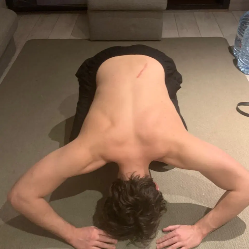 A throwback image of a person training with heavy water bottles, highlighting the beginning of their fitness journey