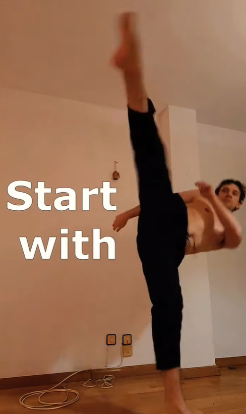 Person practicing a roundhouse kick in their living room.